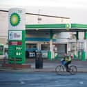 A man cycles past a BP filling station on Spekehall Road in Liverpool, Merseyside. Profits hit record highs at the oil giant BP last year as the business benefited from runaway oil and gas prices caused by the war in Ukraine. Picture date: Tuesday February 7, 2023.