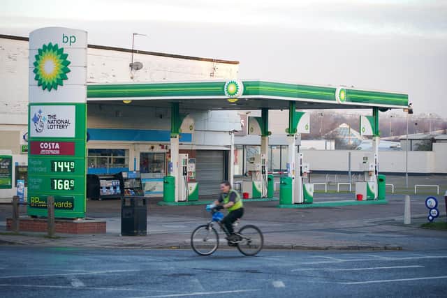A man cycles past a BP filling station on Spekehall Road in Liverpool, Merseyside. Profits hit record highs at the oil giant BP last year as the business benefited from runaway oil and gas prices caused by the war in Ukraine. Picture date: Tuesday February 7, 2023.