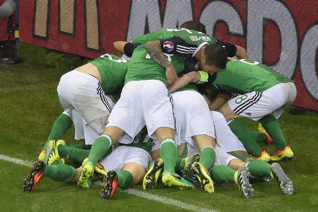 Northern Ireland players celebrate after scoring during the Euro 2016 group C football match between Ukraine and Northern Ireland at the Parc Olympique Lyonnais stadium in Décines-Charpieu near Lyon on June 16, 2016.