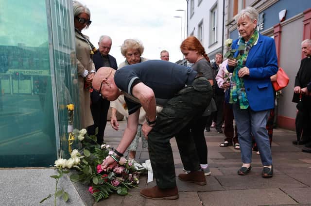 Kevin Skeldon, whose wife Philomena died in the Omagh bombing, lays flowers at the site of the bombing to mark the 25th anniversary of the Real IRA atrocity. Photo. Liam McBurney/PA Wire