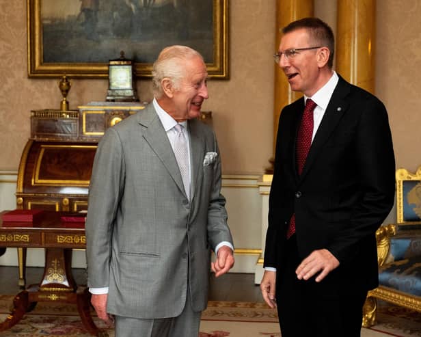 Britain's King Charles III (L) meets Latvia's President Edgars Rinkevics during a private audience at Buckingham Palace in central London on May 28, 2024