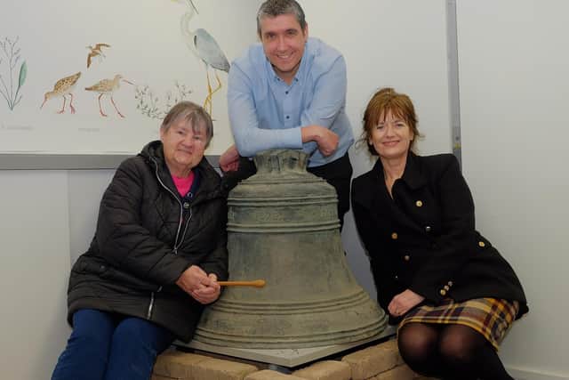 Gareth Morgan, from the Housing Executive, hands over the Shrigley Bell for safe keeping to Dr Elizabeth Crilly (right), from the Sir Hans Sloane Centre in Killyleagh. Belle Russell was also there representing the residents of Shrigley village. Photo by LiamMcArdle