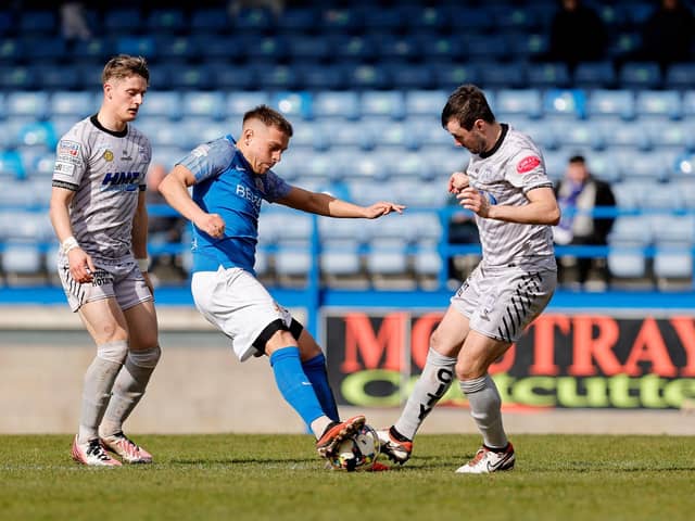Jack Malone (centre) competing with Newry City's Fra McCaffrey in the home win for Glenavon. (Photo by Alan Weir/Pacemaker Press)