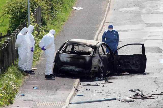 Forensics at the scene of a booby-trap car bomb attack on an off-duty Catholic policeman on the Drumnaby Road outside Castlederg in Co Tyrone