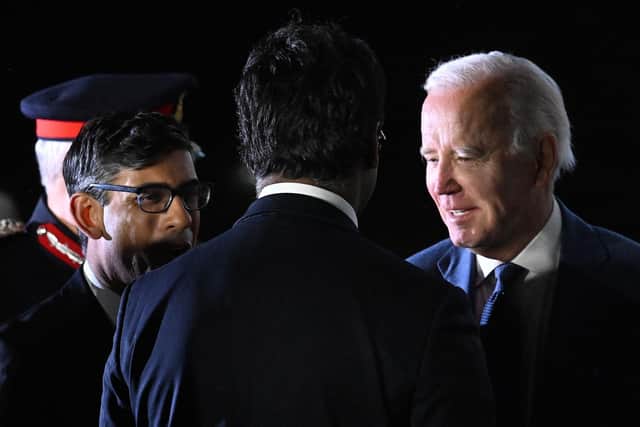 A second phooto showing US President Joe Biden as he is greeted by Britain's Prime Minster Rishi Sunak after disembarking from Air Force One upon arrival at Belfast International Airport on April 11, 2023.