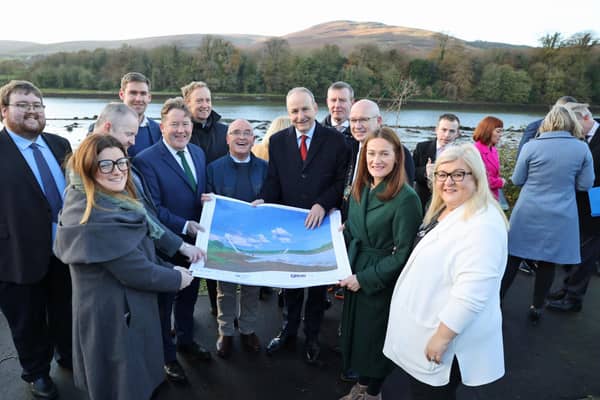 Taoiseach Micheal Martin (centre) and Minister for Housing Darragh O'Brien (fifth left) with local dignitaries at Narrow Water, near Warrenpoint in Co Down, as the government announce a tender process for a new cross-border bridge linking the Mourne Mountains to the Cooley Peninsula. The bridge is a long-standing infrastructure commitment and the Government reiterated its intent to progress the project in the 2020 New Decade, New Approach (NDNA) deal that restored Stormont powersharing. Issue date: Friday November 18, 2022.