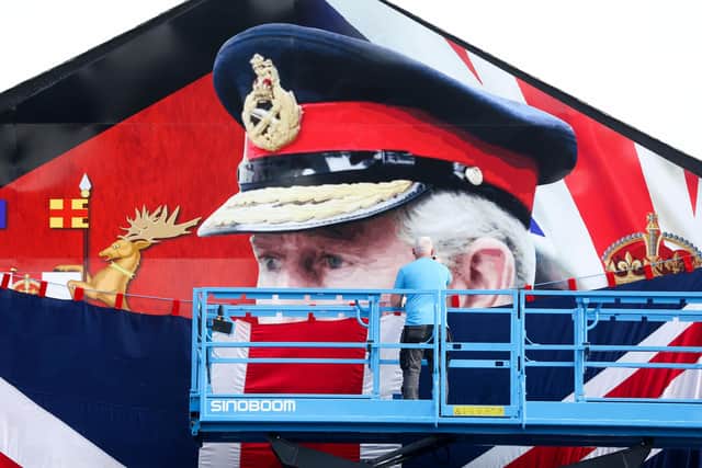 Final touches are made to a mural of Kings Charles III, on the Shankill Road in west Belfast, ahead of his Coronation tomorrow at Westminster Abbey. The mural was to be unveiled by the oldest people living in the area on Friday night.  It is on the opposite side of the road to one dedicated to his mother the late Queen Elizabeth II, who died last year. 
Picture by Jonathan Porter/PressEye