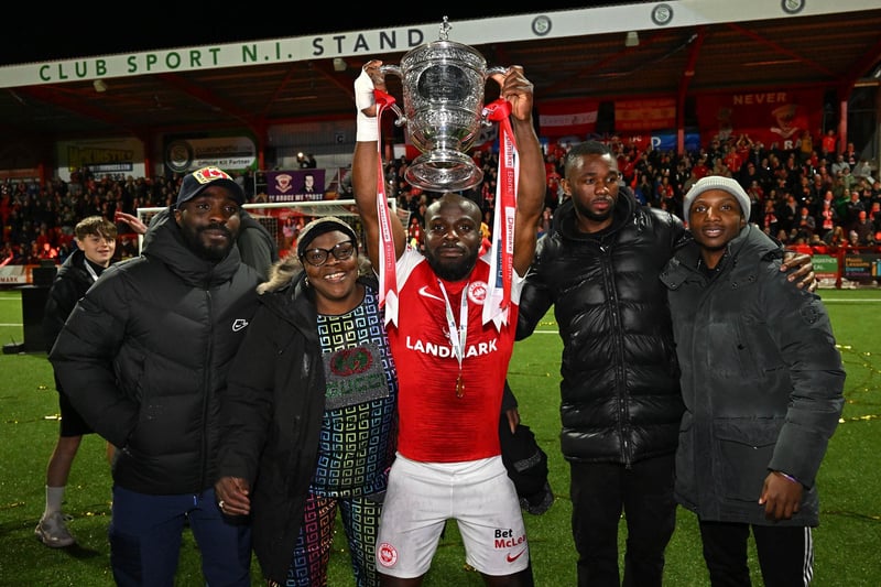 Midfielder Fuad Sule, who played a key role in Larne's success, celebrates with the Premiership title