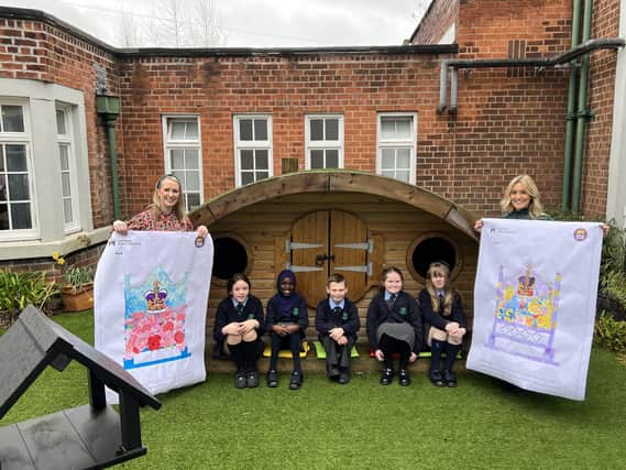 Blythefield Primary School principal, Catherine Roulston, and art-co-ordinator, Serena Caig, with pupils and their winning Coronation Bench designs