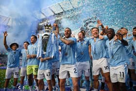 Manchester City's Kyle Walker lifts the Premier League Trophy following a fourth title success in a row for Pep Guardiola's side