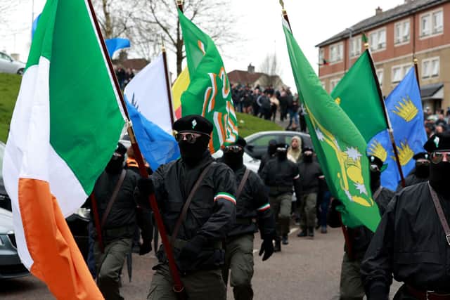 A colour party arrive at the City Cemetery in Londonderry, after their Easter Monday parade through the Creggan area of Londonderry