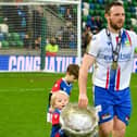 Linfield captain Jamie Mulgrew celebrated his 23rd major career medal on Sunday with family after victory over Portadown in the BetMcLean Cup final. (Photo by Andrew McCarroll/Pacemaker)