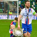 Linfield captain Jamie Mulgrew celebrated his 23rd major career medal on Sunday with family after victory over Portadown in the BetMcLean Cup final. (Photo by Andrew McCarroll/Pacemaker)