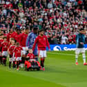 Bruno Fernandes of Manchester United leads out his team-mates alongside mascot Bobby Moore prior to the Premier League match between Manchester United FC and Manchester City FC at Old Trafford on April 5, 2025 in Manchester, United Kingdom. (Photo by Ash Donelon/Manchester United via Getty Images)