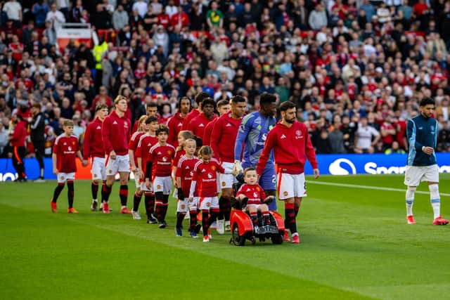 Bruno Fernandes of Manchester United leads out his team-mates alongside mascot Bobby Moore prior to the Premier League match between Manchester United FC and Manchester City FC at Old Trafford on April 5, 2025 in Manchester, United Kingdom. (Photo by Ash Donelon/Manchester United via Getty Images)