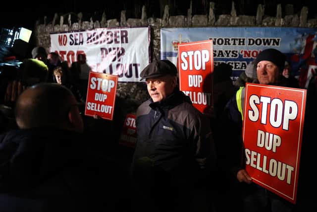 Mel Lucas, from Traditional Unionist Voice, speaks to the media as he joined protesters outside Larchfield Estate where the DUP were holding a private party meeting on Monday night. The protesters were calling for the DUP not to go back into Stormont until the Irish Sea Border is removed. Photo: Liam McBurney/PA Wire