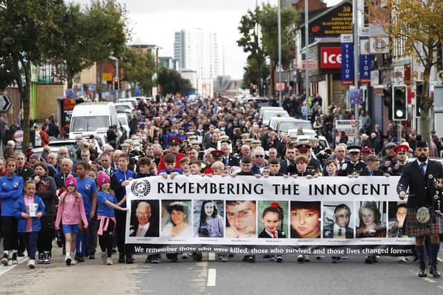 People walk along Shankill Road in Belfast, during an event to mark the 30th anniversary of the Shankill bomb. Picture date: Saturday October 21, 2023.  Photo: Peter Morrison/PA Wire