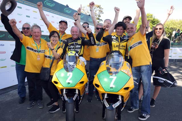 Mike Browne celebrates winning the Lightweight Manx Grand Prix in 2022 with team-mate Ian Lougher and the Laylaw Racing team