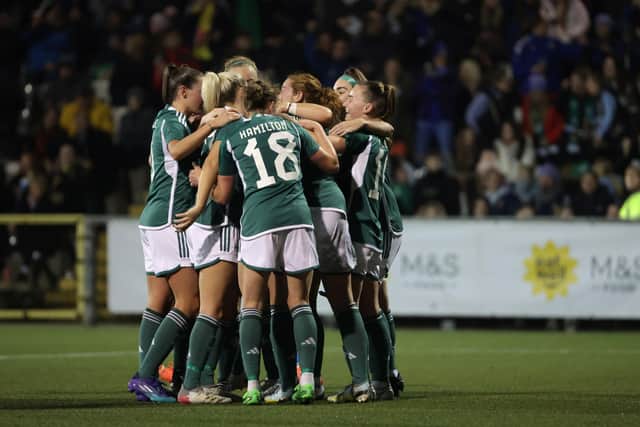 Northern Ireland players celebrate with Sarah McFadden following her goal against Italy at Seaview on Tuesday night.