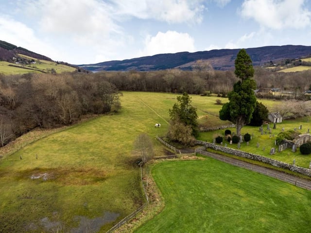 Aerial view over paddocks and beyond.