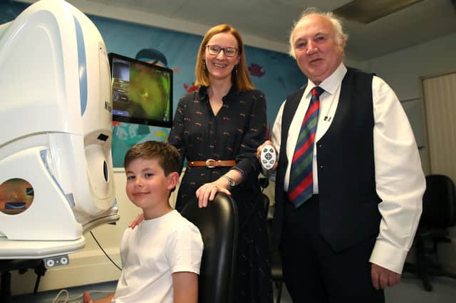 Louis Gilliland (aged 9), Ms. Eibhlin McLoone, Consultant Paediatric Ophthalmologist in Belfast Trust and Dr Terry Cross OBE.