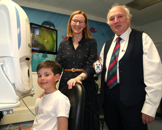 Louis Gilliland (aged 9), Ms. Eibhlin McLoone, Consultant Paediatric Ophthalmologist in Belfast Trust and Dr Terry Cross OBE.