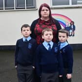 Parent Joyce Holmes with her children Daniel, Adam and Mathew Shields. The decision to close their school, Kingsmills Primary School, has left them devastated, she said. Pic Pacemaker