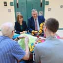 Governor of Maghaberry Prison, David Savage and Julie McConville, Assistant Director for Specialist Child Health and Disability with the Southern Health & Social Care Trust, review the crocheting work of the 'Stitch in Time Gang' (Image: Michael Cooper)