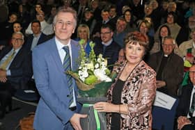 Dr Tim Campbell presents singer Dana with a bunch of flowers thanking her for her prescence at the launch of the new exhibition at the St Patrick Centre in Downpatrick