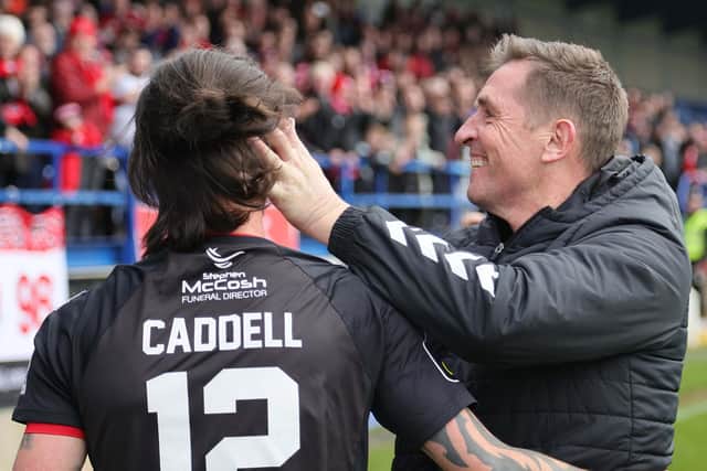 Crusaders manager Stephen Baxter embraces goal scorer Declan Caddell after the Samuel Gelston's Whiskey Irish Cup semi-final win over Dungannon Swifts at Mourneview Park, Lurgan on April 1