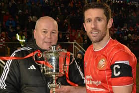 Irish FA first deputy president Neil Jardine presents the Euro-Electrix Mid-Ulster Senior Cup to Portadown captain Gary Thompson following Tuesday's 5-2 victory over Dungannon Swifts at Shamrock Park. (Photo by Eamonn Shanks)