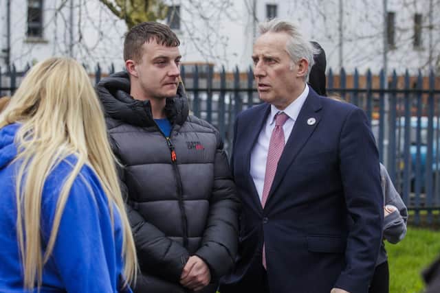Philip Mitchell, the brother of Chloe Mitchell speaks to DUP MP Ian Paisley (right) after a memorial event for Chloe Mitchell at King George's Park, Ballymena