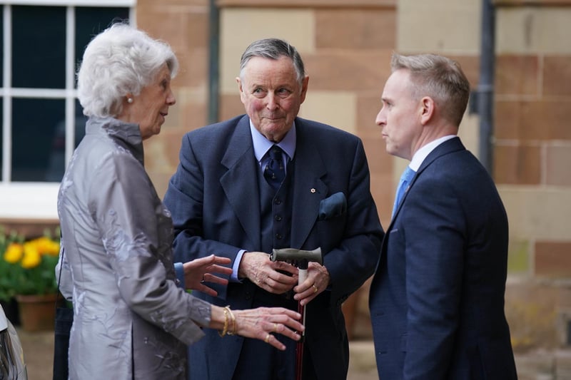 John de Chastelain and wife Mary Ann is welcomed by Ryan Feeney (right) of Queen's University at a Gala dinner to recognise Mo Mowlam's contribution to the peace process and to mark the 25th anniversary of the Good Friday Agreement at Hillsborough Castle in Northern Ireland.