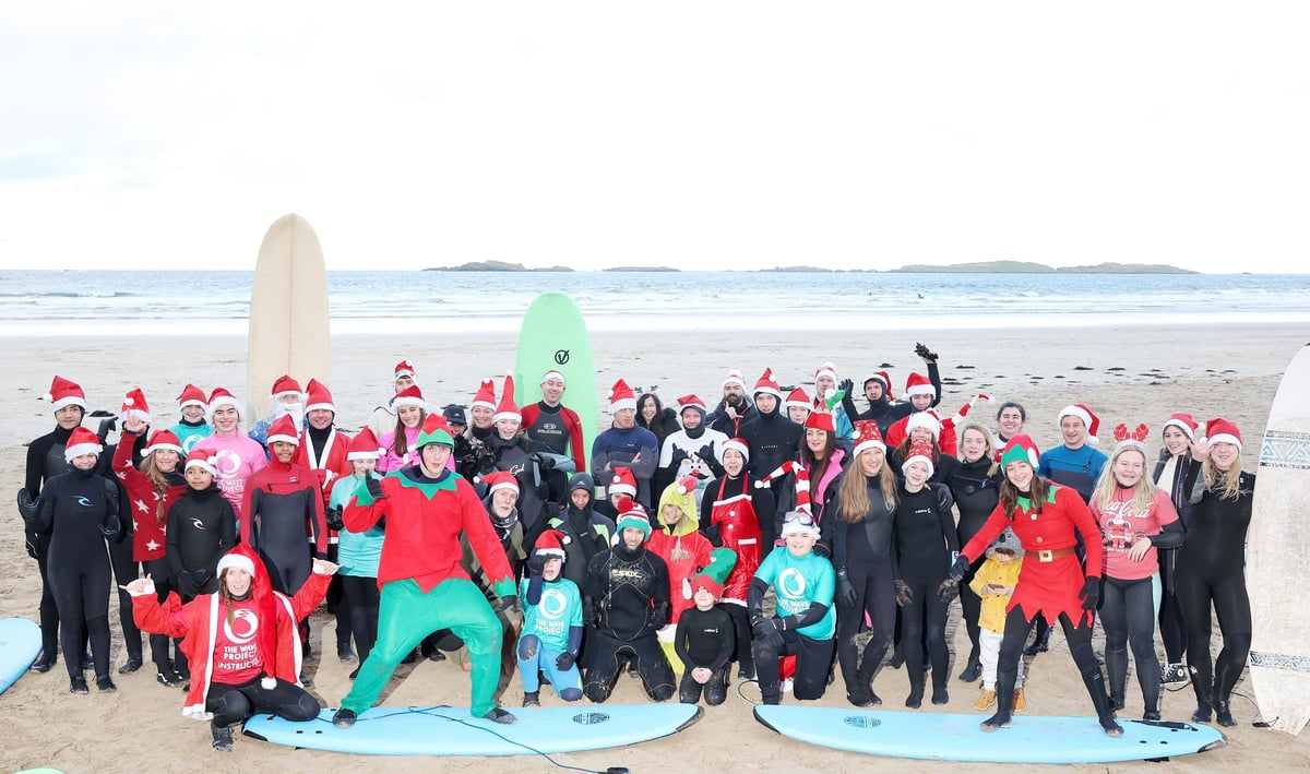 Surfers take to the sea for the 4th annual Wave Project Santa Surf at east Strand Portrush