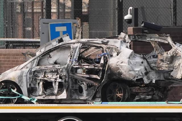 The remains of the exploded vehicle being removed from the streets of Dunmurry on the outskirts of Belfast. Photo: Niall Carson/PA Wire