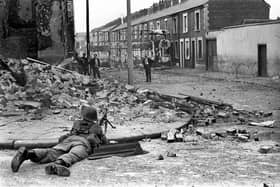 A British Army soldier on lookout in the Falls Road area of Belfast. Philip Barden, from legal firm Devonshires, has welcomed new laws to deal with the legacy of the Troubles