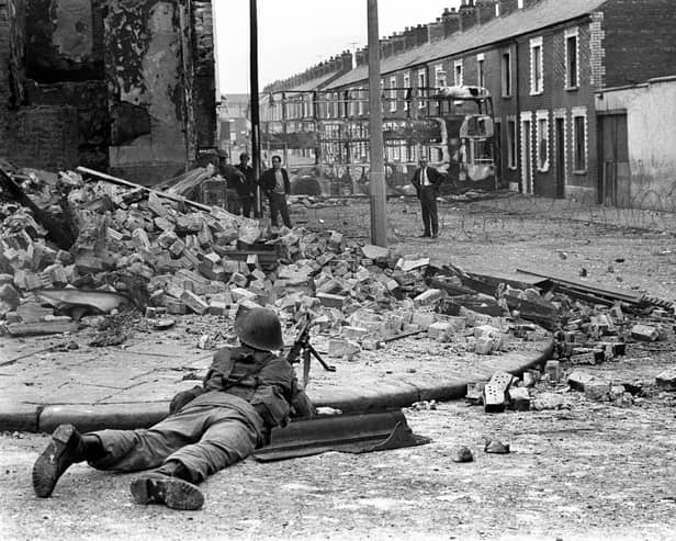 A British Army soldier on lookout in the Falls Road area of Belfast. Philip Barden, from legal firm Devonshires, has welcomed new laws to deal with the legacy of the Troubles