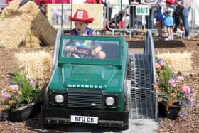 Eight-year-old Sonny Caffrey from Meath practices his driving skills in a mini Land Rover. (Photo: Jonathan Porter/Press Eye)