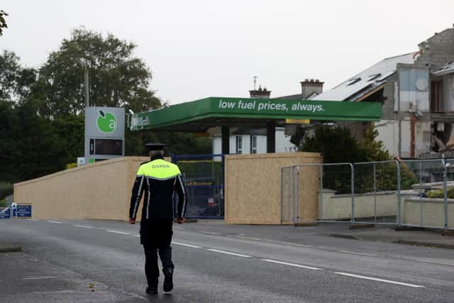 A member of An Garda Siochana walks towards the scene of an explosion at Applegreen service station in the village of Creeslough in Co Donegal where ten people were killed. Picture date: Monday October 10, 2022.