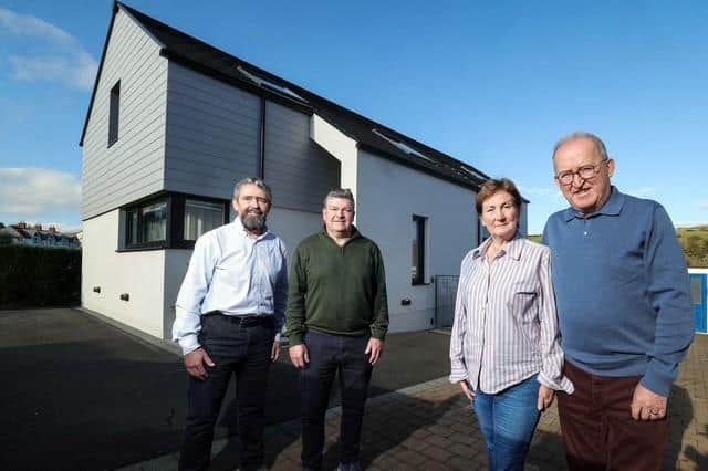 Pictured (from left) are Mark and Niall Gribbin, Directors of Setanta Construction; with homeowners Anne-Marie and Eddie McGoldrick outside their full-electric, smart tech home on the outskirts of Cushendall, Co. Antrim. The energy-efficient property costs just £44 per week to run, including electric vehicle charging, showcasing the potential of modern, sustainable home design and construction. Credit: Supplied