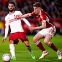 Manchester United's Bruno Fernandes and Nottingham Forest's Ryan Yates battle for the ball in the FA Cup match at the City Ground