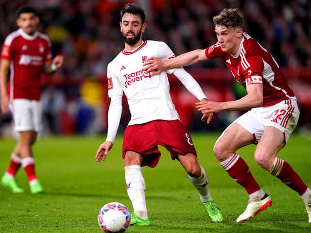 Manchester United's Bruno Fernandes and Nottingham Forest's Ryan Yates battle for the ball in the FA Cup match at the City Ground
