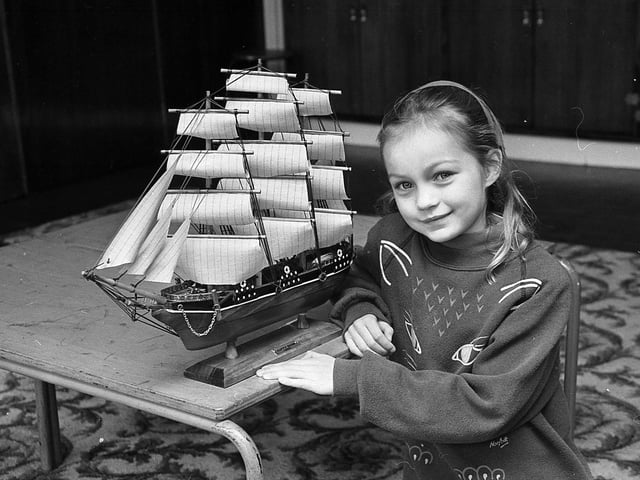 Seven-year-old Victoria Hamilton from the Malone Road, Belfast, pictured at the end of February 1992, admires a model of the Cutty Sark at an antique and memorabilia fair in aid of the USPCA held at Lisburn Road Methodist Church Hall, Belfast. Picture: News Letter archives