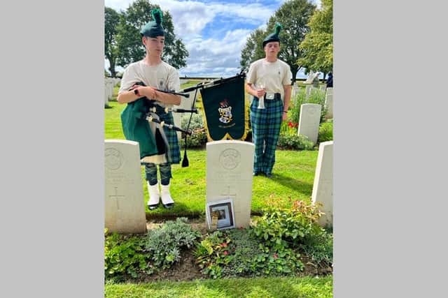 Piper David B and Bugle Major Harry Murphy at the grave of Old Campbellian Arthur Lidwell at St Manvieu CWGC