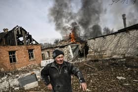 A man stands outside a burning house after shelling in the town of Chasiv Yar, near Bakhmut,  yesterday (March 21, 2023), amid the Russian invasion of Ukraine. In any war there will always be allegations of war crimes from either of the protagonists. The ICC could have found cases of war crimes inflicted against Protestants in Northern Ireland but do we think they would have prosecuted the IRA? (Photo by Aris Messinis / AFP)