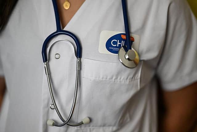 Nurses in NI were hoping for a 3.3% pay hike back in April (general image of a nurse with a stethoscope by Gabriel BOUYS / AFP via Getty Images)