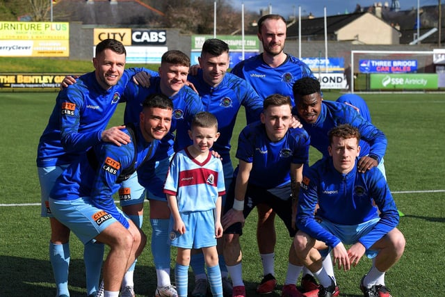 Young Institute fan poses for a photo with Institute players at the Brandywell  on Sunday afternoon. George Sweeney