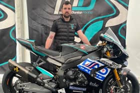 Michael Dunlop with the MasterMac by Hawk Racing Honda Superbike in the paddock at the North West 200
