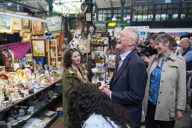 Hilary Benn speaks with a market trader during a visit to St George's Market in Belfast on Sunday. He said "there is no evidence" that the grounds for a border poll have been met. Photo: Niall Carson/PA Wire