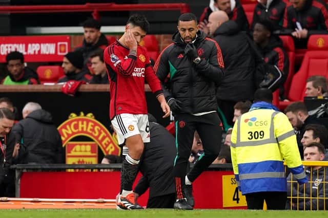 Manchester United's Lisandro Martinez leaves the game after picking up an injury on Sunday against West Ham United. (Photo by Martin Rickett/PA Wire)